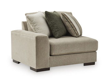 Corner chair with light beige linen-look upholstery and square arms; includes patterned throw pillows