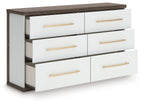Six-drawer dresser with open drawers, white interior and warm wood top, gold bar pulls.