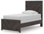 Panel bed with dark gray chevron headboard, white mattress, matching platform footboard