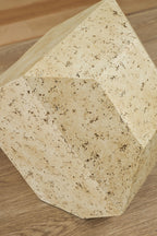 Beige speckled angular sculpture, close-up of faceted sides