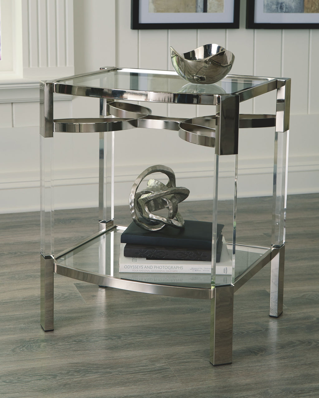 Clear glass accent table with silver frame, two-tier shelving and rounded corners