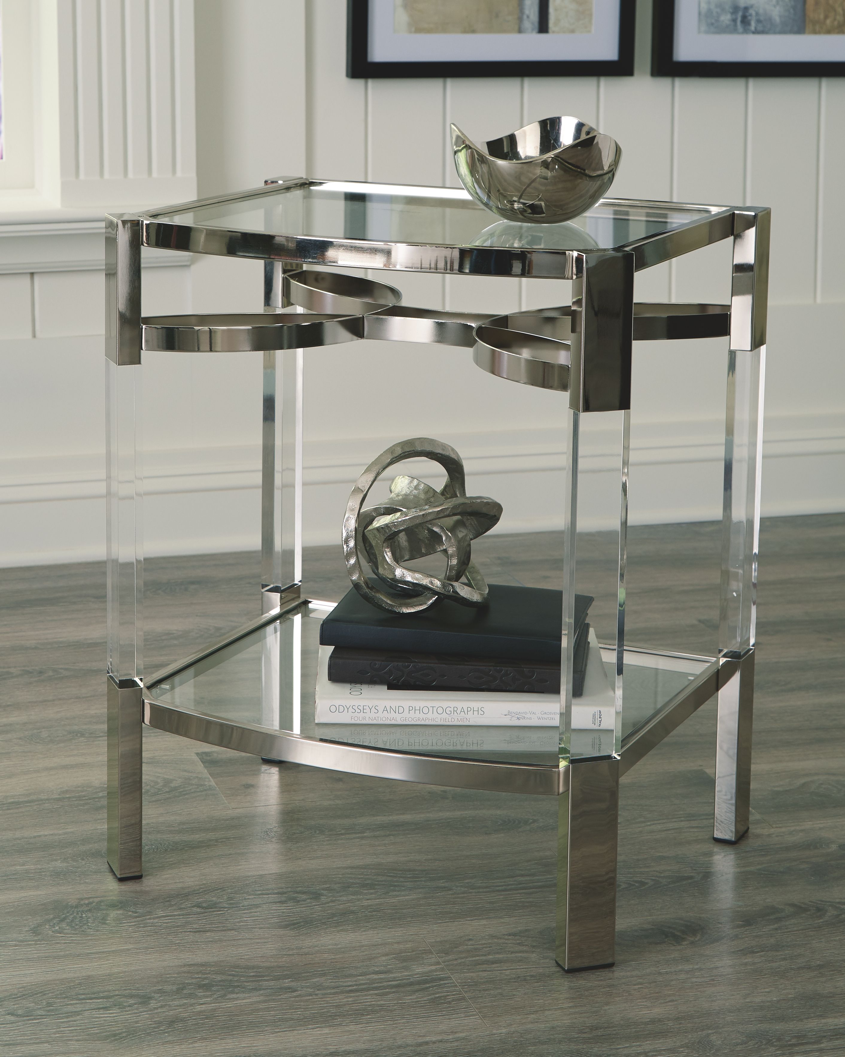 Clear glass accent table with silver frame, two-tier shelving and rounded corners