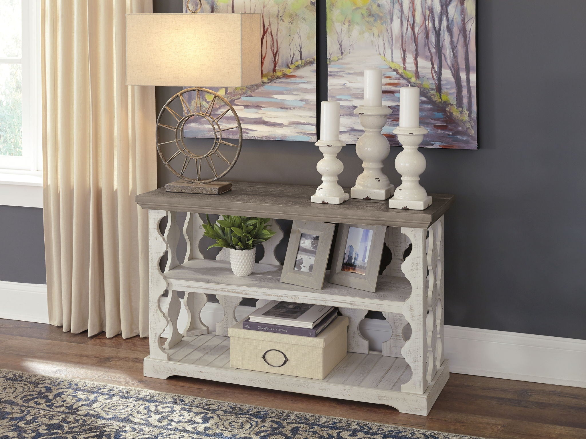 Gray console sofa table with white carved sides and two open shelves