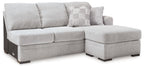 Light gray fabric chaise sofa with square arms and patterned accent pillow