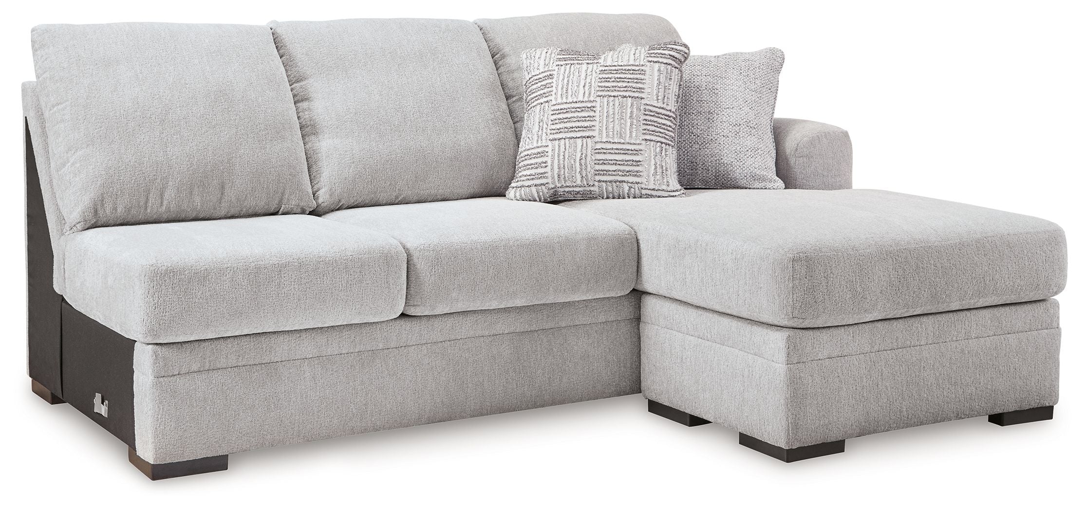 Light gray fabric chaise sofa with square arms and patterned accent pillow