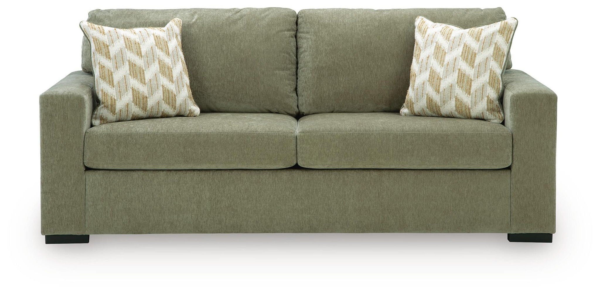 Green sofa sleeper with two patterned throw pillows and rounded armrests