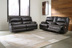 Black leather-look sofa and loveseat with padded arms and tufted back cushions