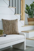 Textured dark brown and cream decorative pillow on a couch