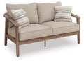 Natural fabric loveseat with two striped accent cushions and beige seat cushions
