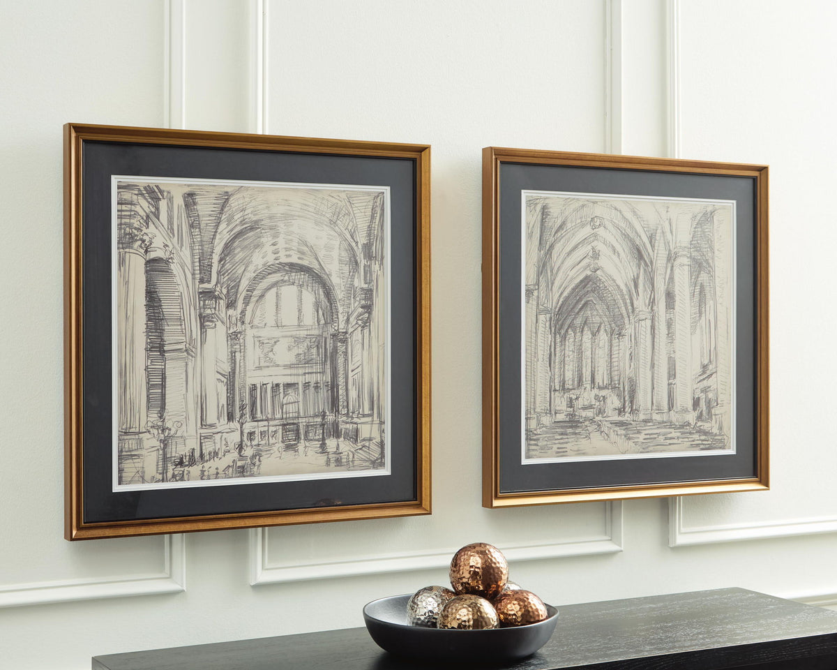 Two framed cathedral sketch prints with gold-tone frames, displayed on a wall