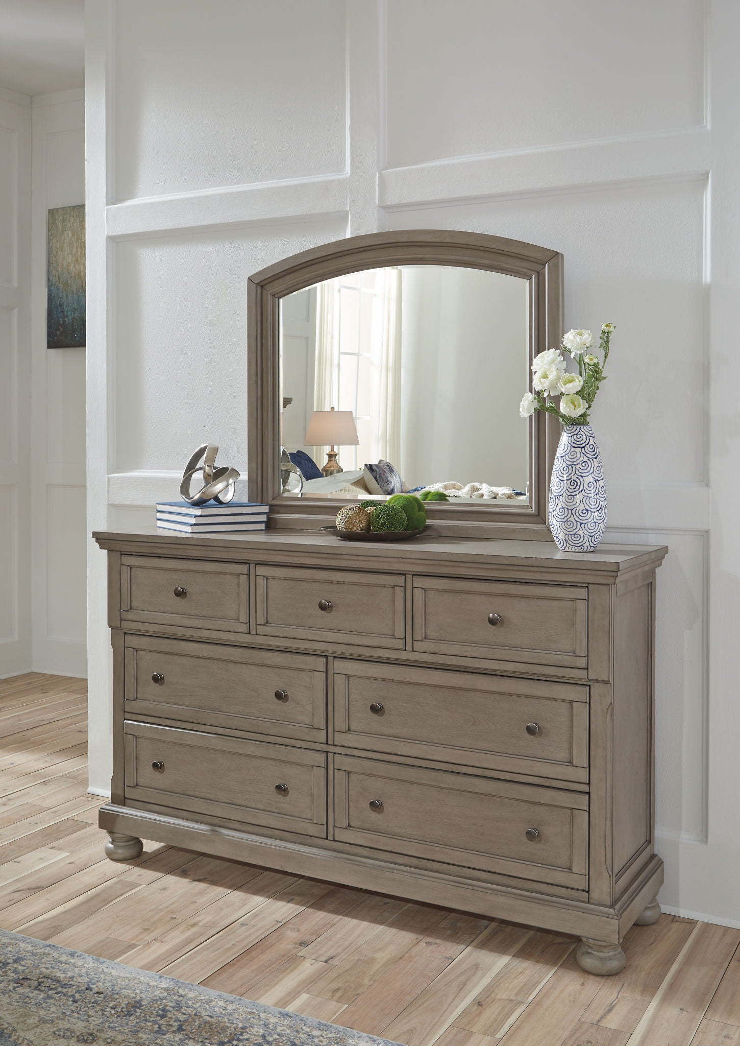 Gray dresser with arched mirror, nine drawers with metal pulls