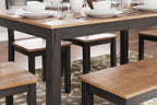 Dining table corner with dark wood legs and light seat benches