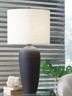 Dark metal table lamp with beige fabric drum shade and matte finish