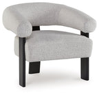 Light gray upholstered accent chair with curved armrests and dark wooden legs