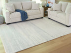 Light blue and white abstract rug with horizontal bands and subtle texture