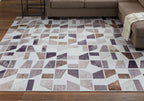 Jettner area rug geometric mosaic pattern in light gray and dark navy with brown accents