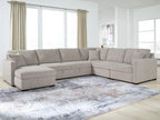 Gray sectional sofa with corner chaise and low ottoman-style side cushion