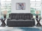 Reclining power sofa with dark gray tufted back and wide padded seats