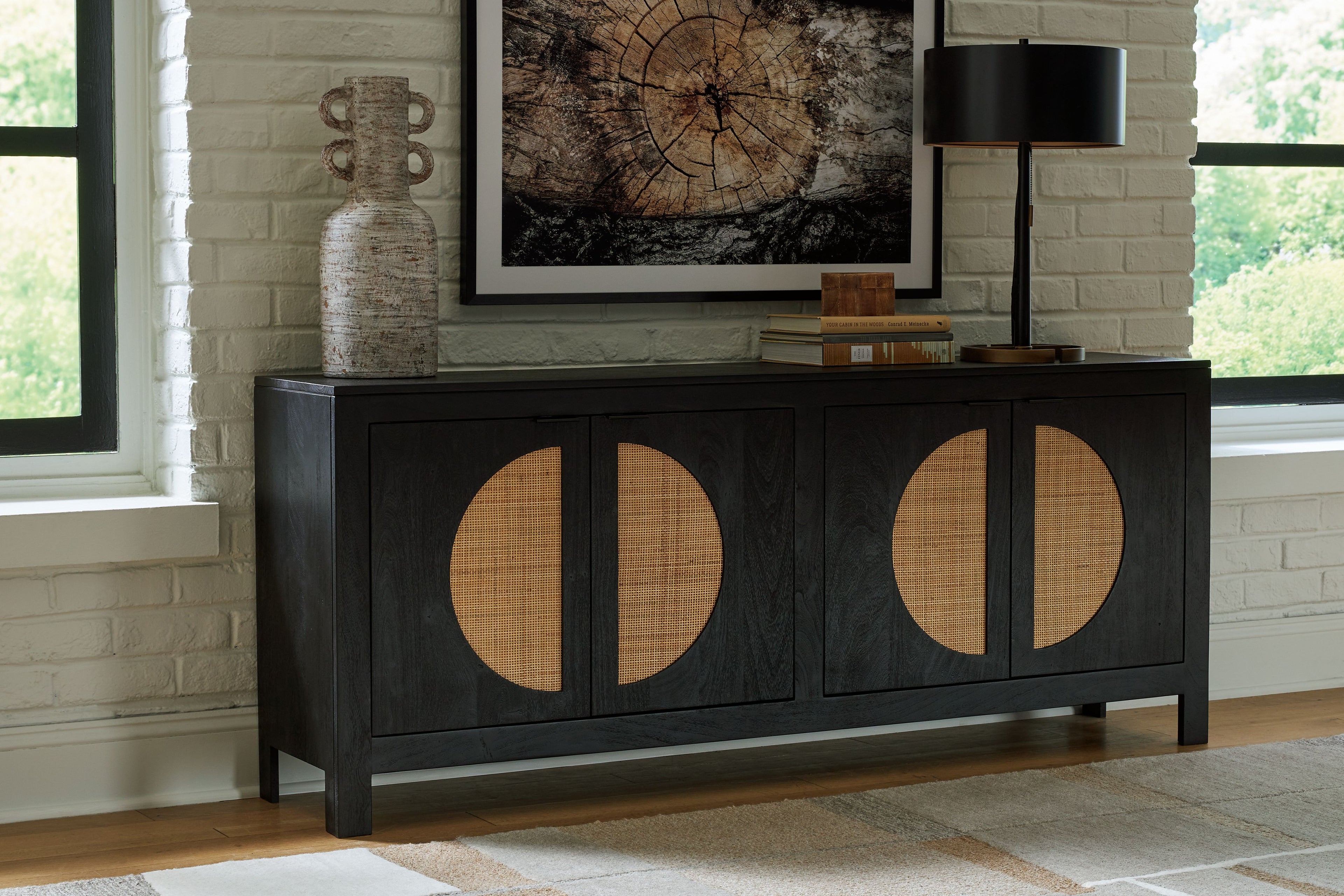 Black accent cabinet with four circular doors and natural wood inserts