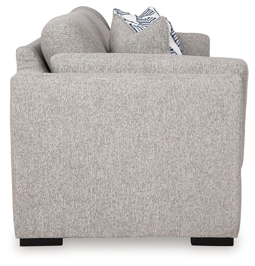 Gray upholstered chair with striped accent pillow on back cushion