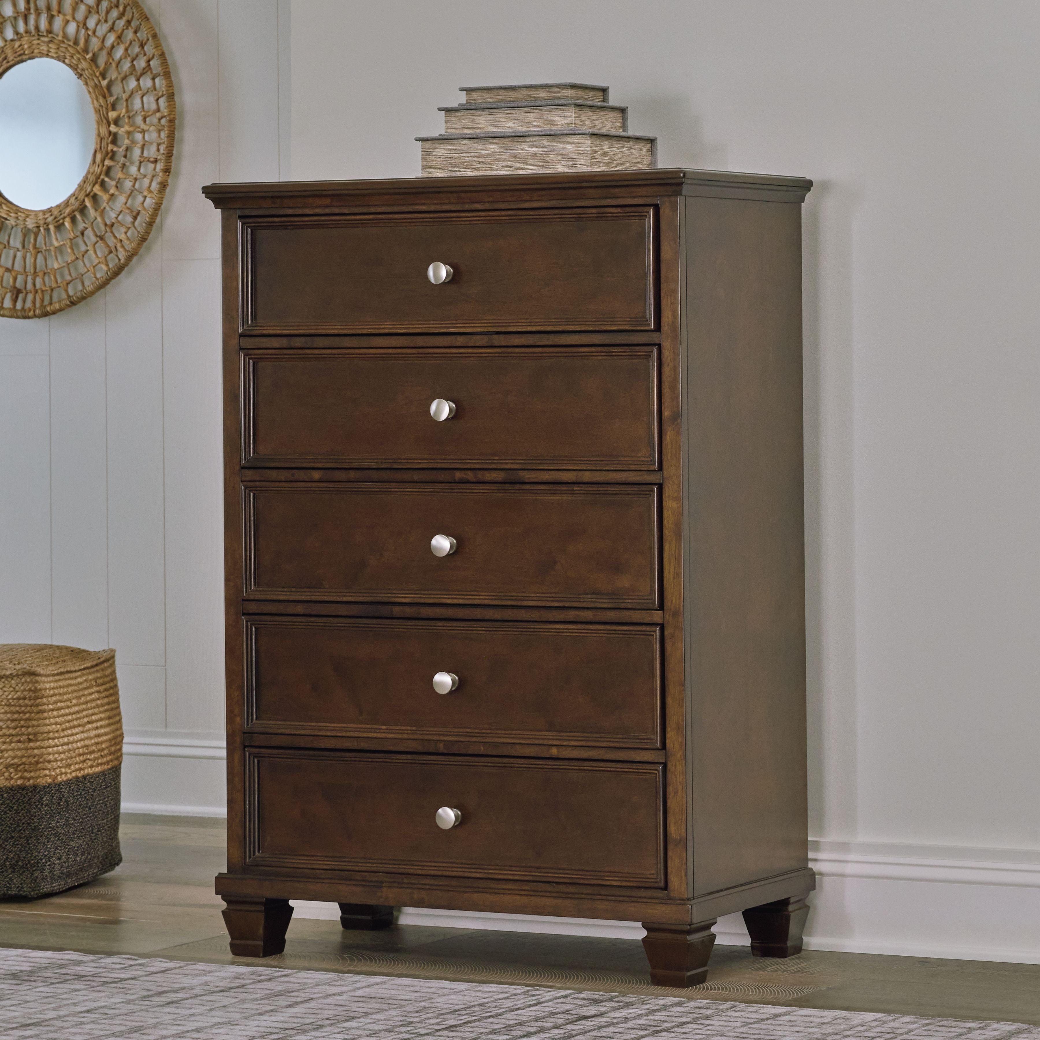 Brown five-drawer chest with round metal knobs and dark wood finish, on tapered legs
