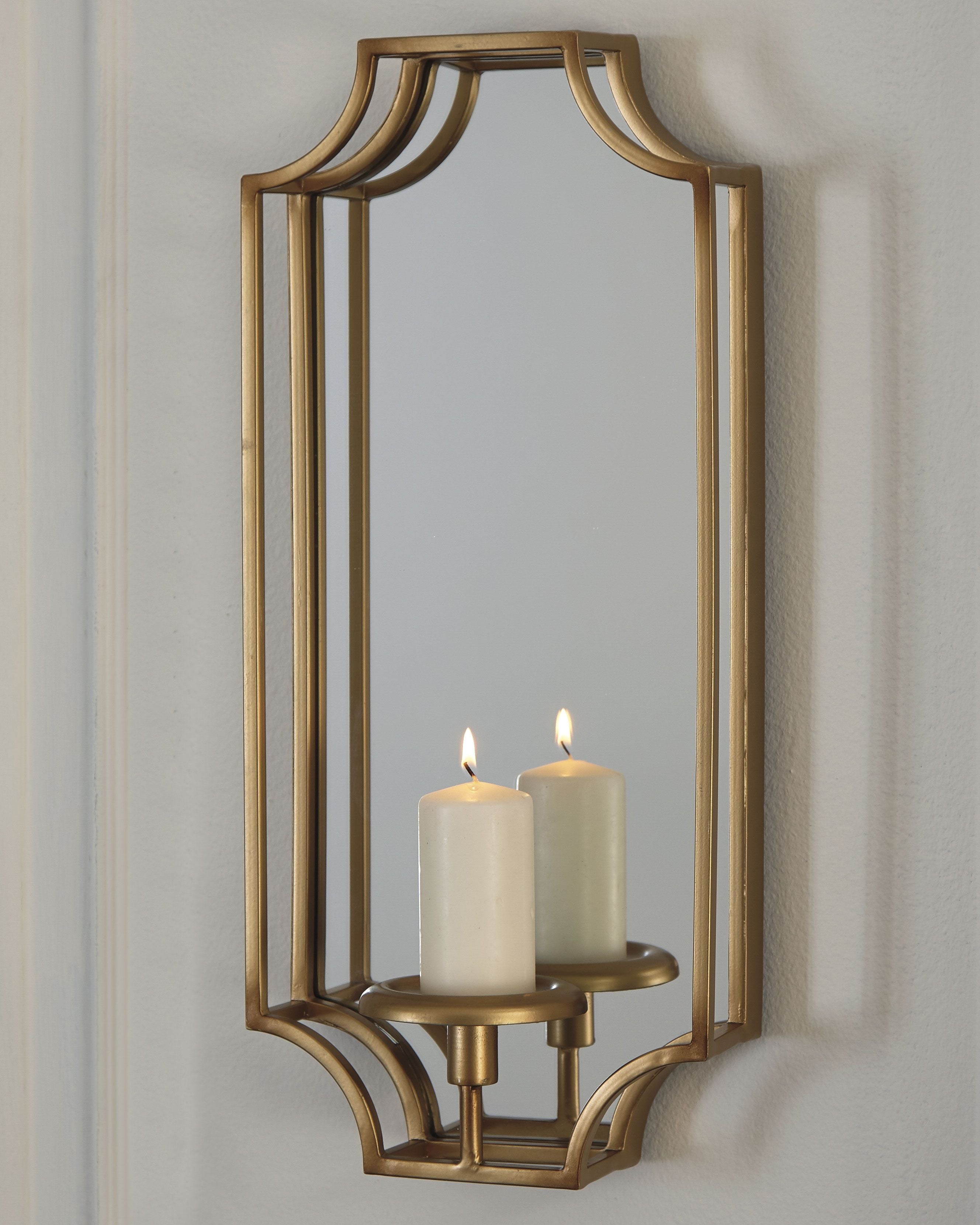 Gold wall sconce with rectangular lantern frame and two lit pillar candles