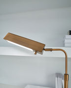 Bronze metal floor lamp with rectangular shade and curved stem on stone base