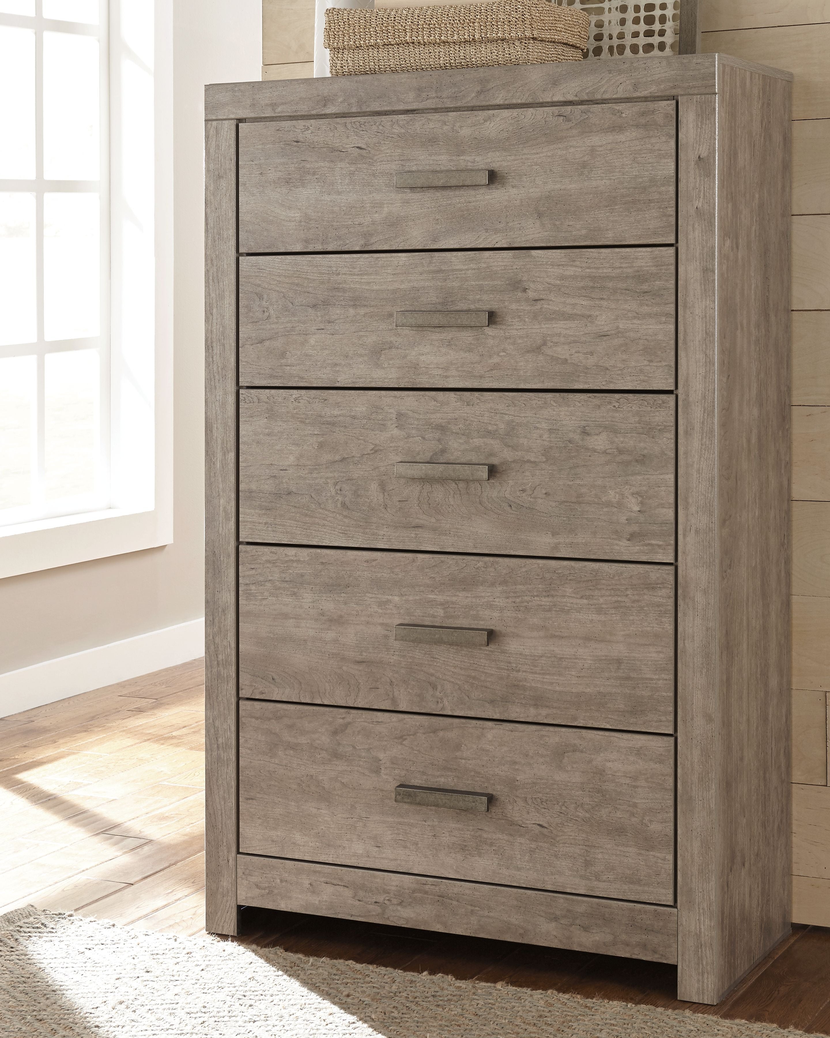 Gray five-drawer chest with four visible drawers and metal bar handles