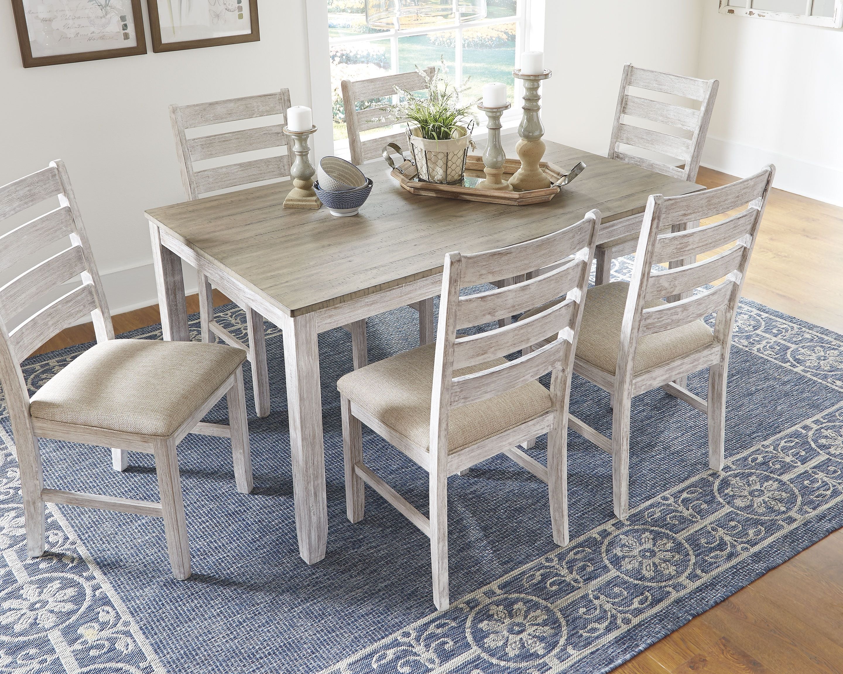 Rectangular dining table with six white chairs, wood-look finish