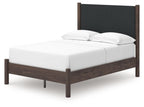 Dark brown upholstered panel platform bed with white mattress and two curved pillows