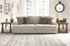 Stone upholstered sofa with three throw pillows