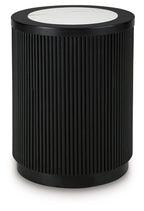 Black ribbed round table with white marble-look top and dark outer rim