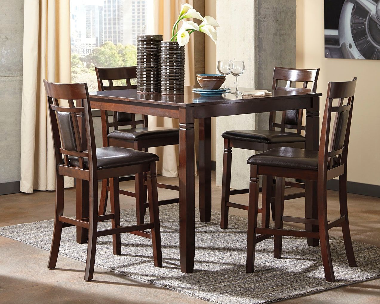 Brown counter-height dining table with four matching chairs