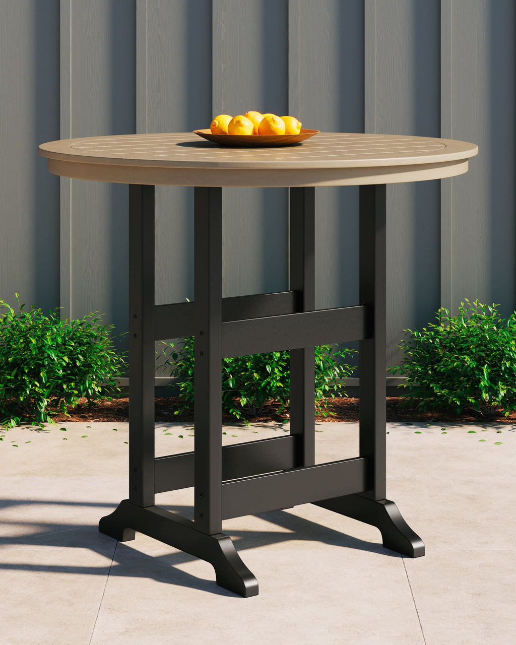 Round bar table with driftwood round top, black legs, and lower open shelf