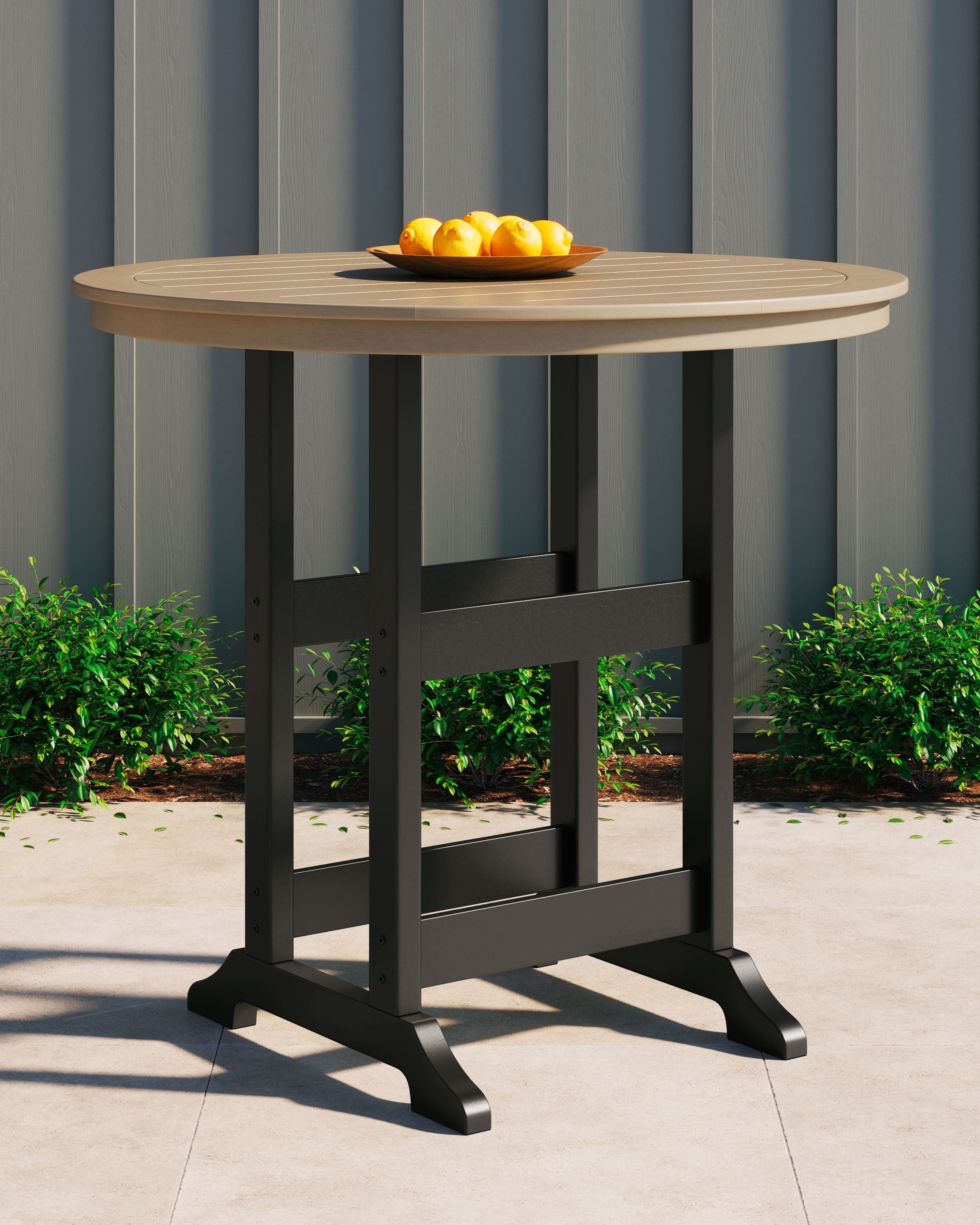 Round bar table with driftwood round top, black legs, and lower open shelf