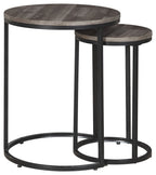 Two round nesting accent tables with gray wood tops and black curved metal bases