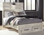 Light wood panel bed with headboard, gray bedding set, and two underbed drawers