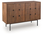 Brown accent cabinet with paneled doors and black metal knobs, raised on legs