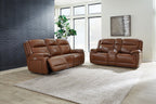Dark brown leather power reclining sofa set with two recliners and padded headrests
