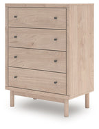 Four-drawer chest with four front drawers and black round knobs, light tan wood