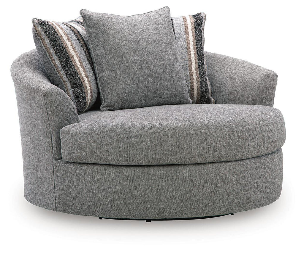 Gray upholstered swivel accent chair with round base and two striped accent pillows