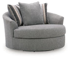Gray upholstered swivel accent chair with round base and two striped accent pillows