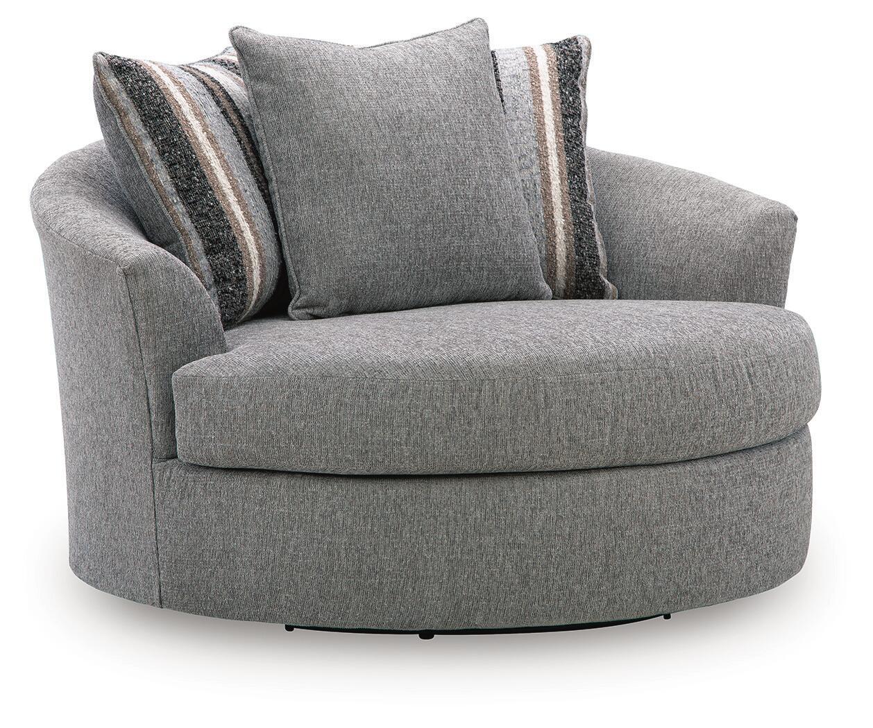 Gray upholstered swivel accent chair with round base and two striped accent pillows