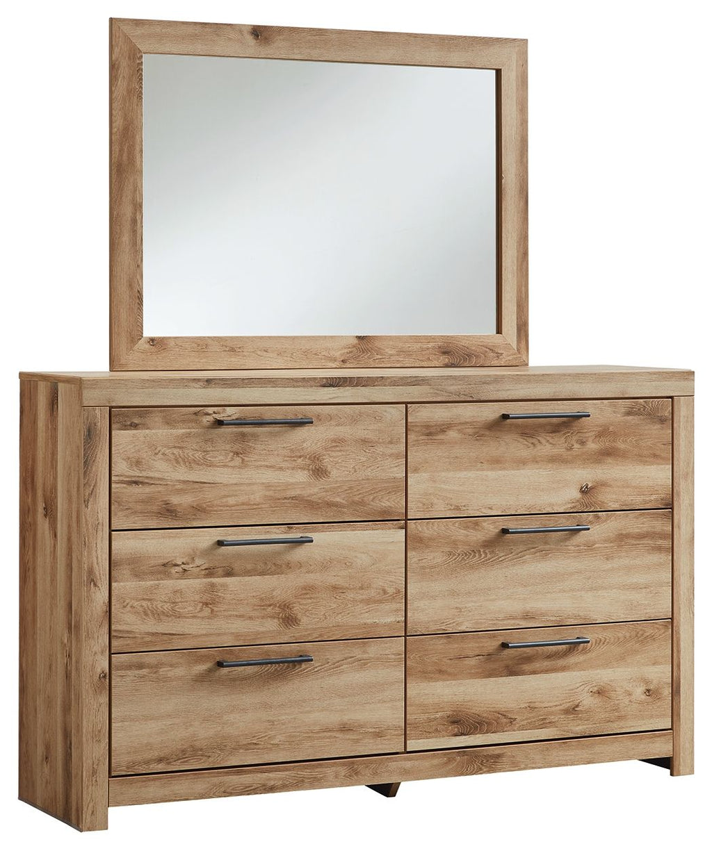 Tan wood dresser with attached mirror and six metal-pull drawers