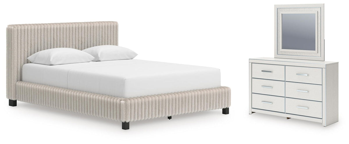 White upholstered bed with matching nightstand and dresser with framed mirror