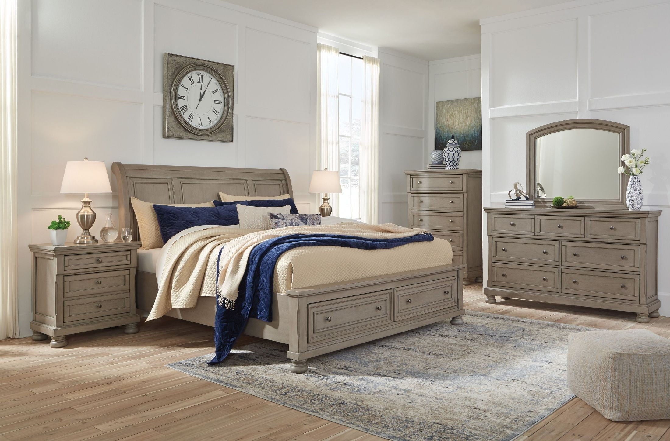 Sleigh bedroom set: upholstered sleigh bed with blue accent bedding and gray casegoods