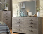 Gray dresser with mirror top and six drawers featuring brushed metal bar pulls.