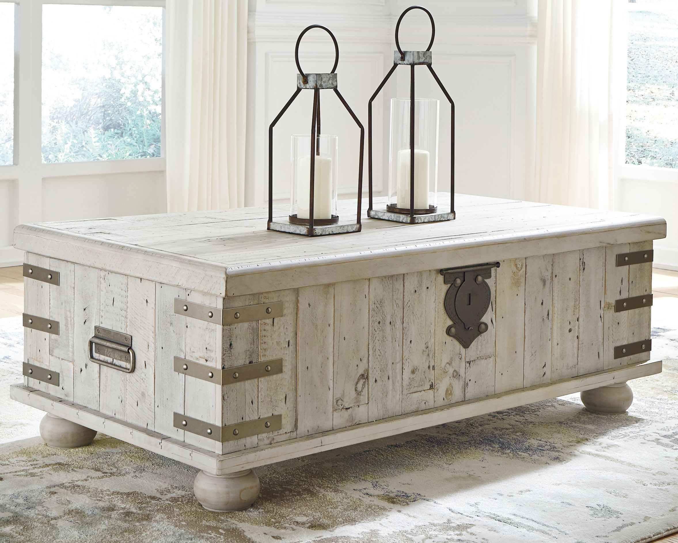 Whitewashed gray lift-top cocktail table with metal strap accents and sturdy legs