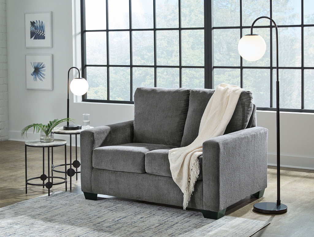 Dark gray sofa set with matching armchair, topped with throws