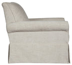 Light beige upholstered swivel glider accent chair, close-up of back and arms.